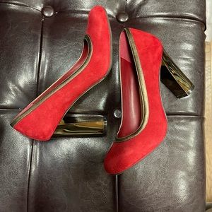 Cole Haan red velvet-textured pumps with gold lining and heels.